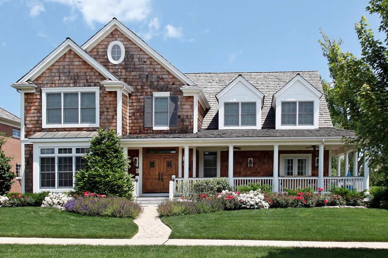Suburban home with flowered landscaping and front porch
